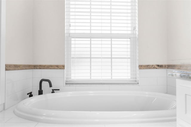 bathroom featuring a bathtub and tile walls