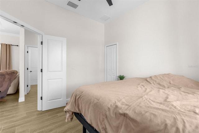 bedroom with ceiling fan and light wood-type flooring