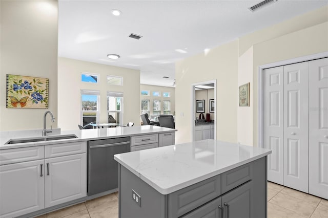 kitchen with gray cabinetry, dishwasher, a center island, sink, and light tile patterned flooring