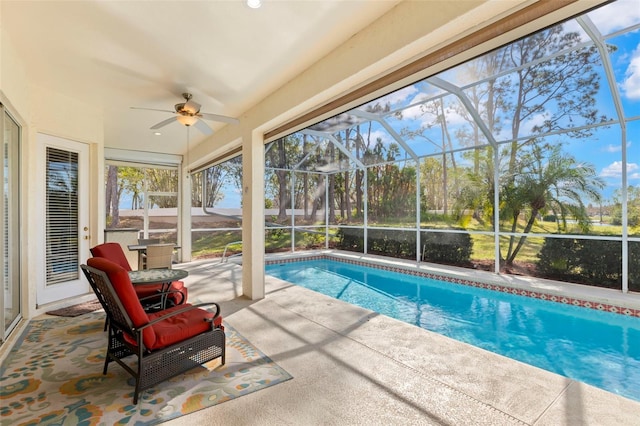 view of pool featuring ceiling fan, a patio area, and a lanai