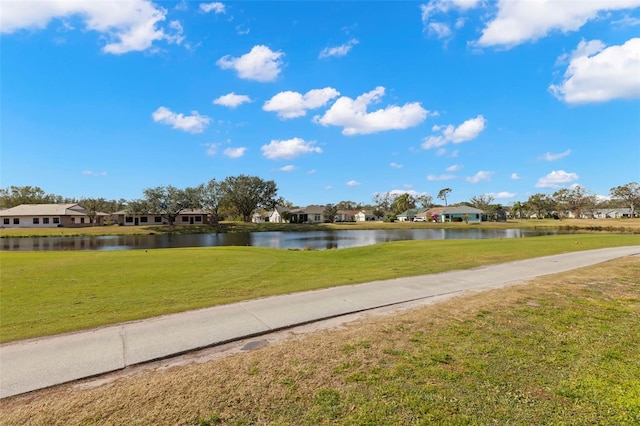 view of community featuring a water view and a lawn