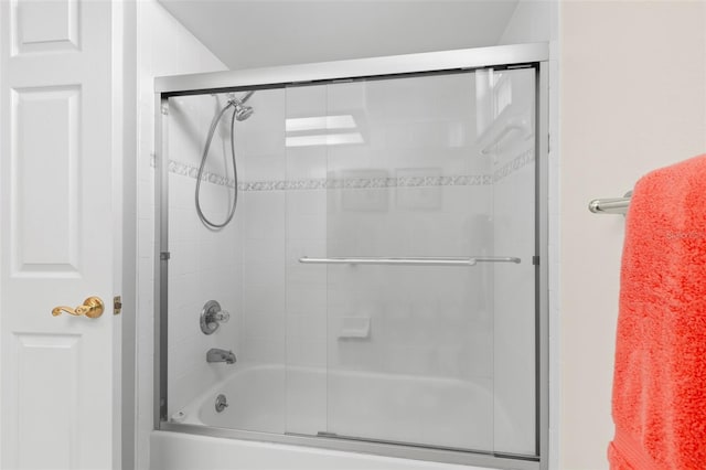 bathroom featuring combined bath / shower with glass door