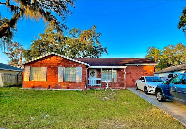 ranch-style house with a front lawn and covered porch