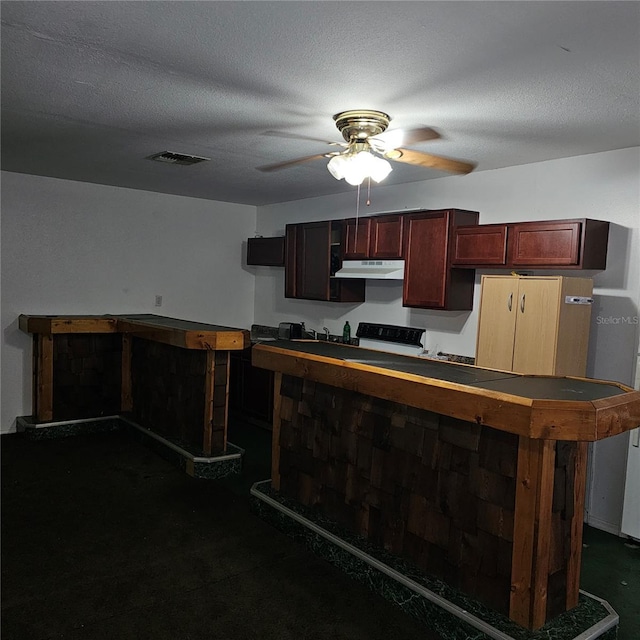 kitchen with ceiling fan and a textured ceiling