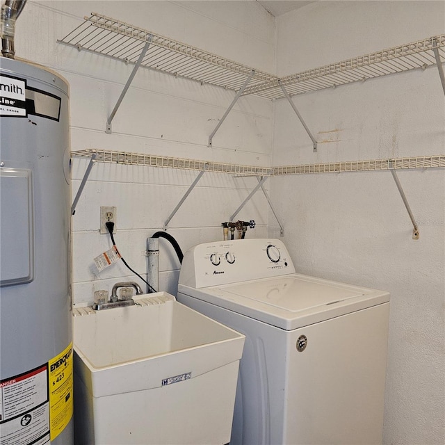 laundry area featuring washer / dryer, sink, and water heater