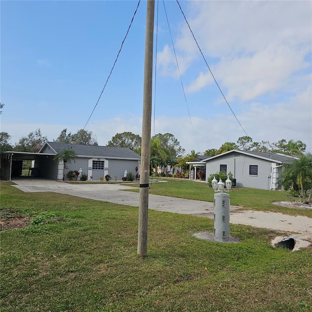 single story home featuring a front yard and a carport