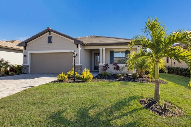 view of front of house with a front yard, a porch, central AC, and a garage