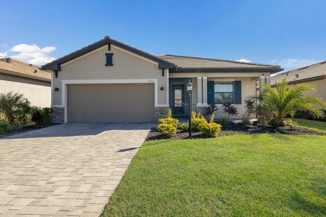 view of front of property featuring a garage and a front lawn