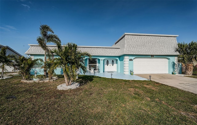 view of front of house with a garage and a front lawn