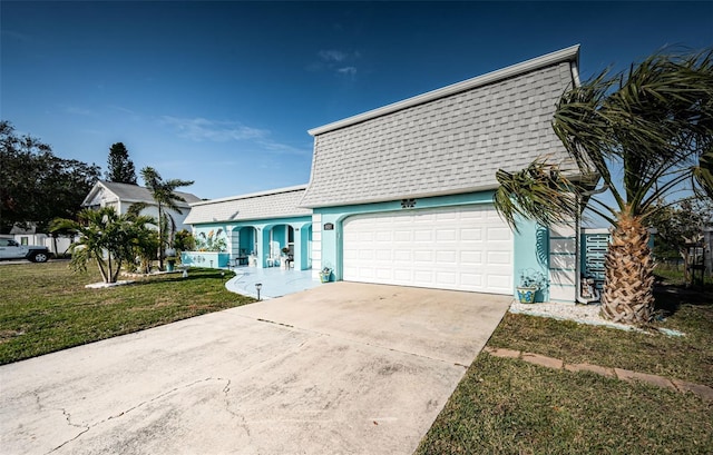 view of front of property with a front yard and a garage