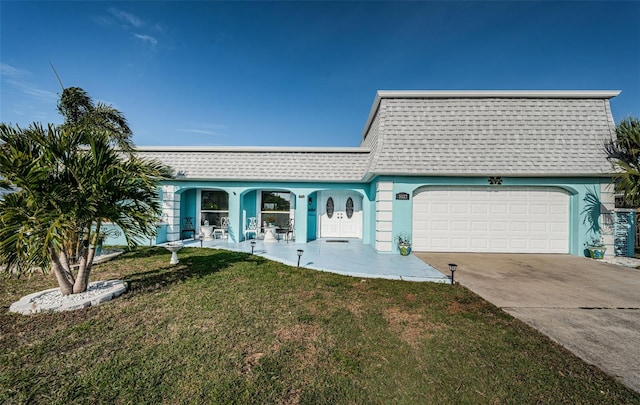 single story home with a garage and a front lawn