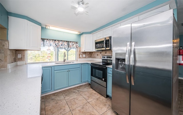 kitchen featuring sink, blue cabinetry, tasteful backsplash, white cabinetry, and stainless steel appliances