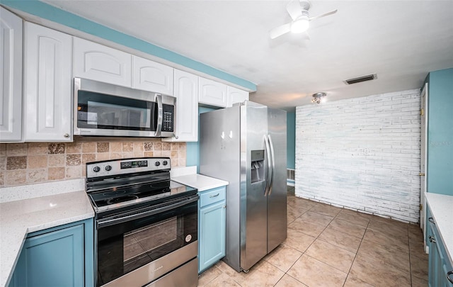 kitchen with decorative backsplash, ceiling fan, blue cabinetry, white cabinetry, and stainless steel appliances