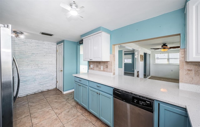 kitchen featuring tasteful backsplash, stainless steel appliances, blue cabinets, white cabinetry, and light tile patterned flooring