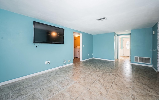 unfurnished living room featuring washer / clothes dryer