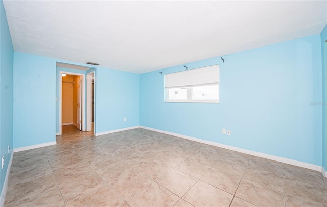 empty room with light tile patterned floors