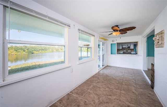 corridor featuring a water view and tile patterned floors