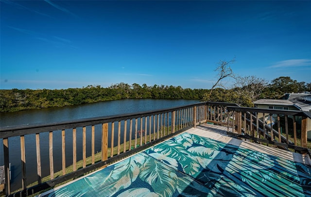 wooden deck featuring a water view