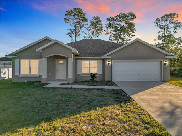 single story home with a yard and a garage