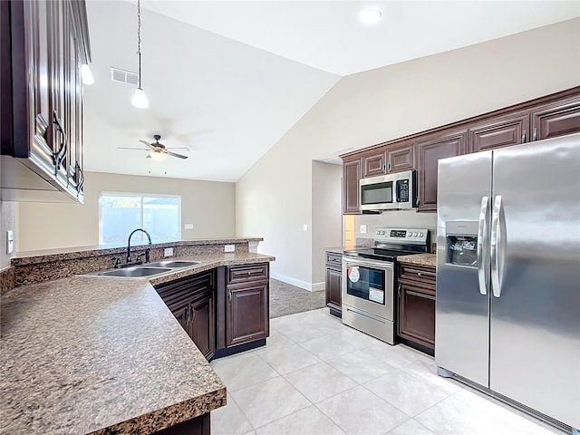 kitchen featuring dark brown cabinetry, ceiling fan, sink, stainless steel appliances, and pendant lighting