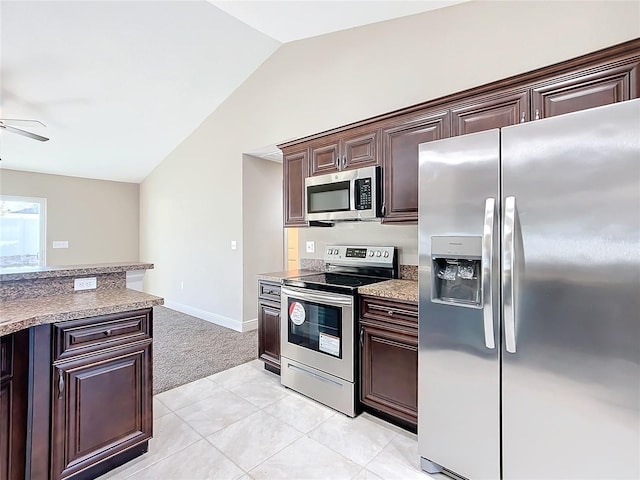 kitchen with ceiling fan, lofted ceiling, dark brown cabinets, light tile patterned flooring, and appliances with stainless steel finishes