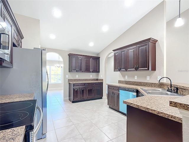 kitchen featuring sink, hanging light fixtures, vaulted ceiling, dark brown cabinets, and appliances with stainless steel finishes