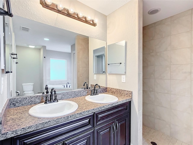 full bathroom featuring vanity, separate shower and tub, and toilet