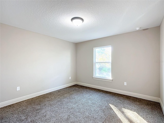 carpeted spare room with a textured ceiling