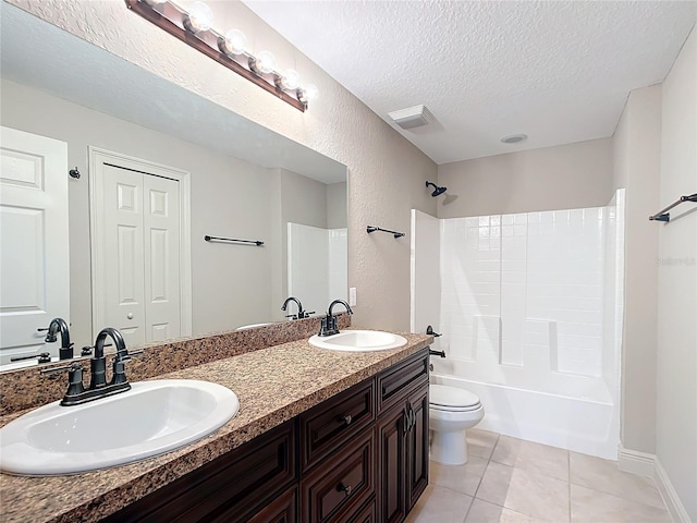 full bathroom with tile patterned floors, vanity, a textured ceiling, bathing tub / shower combination, and toilet