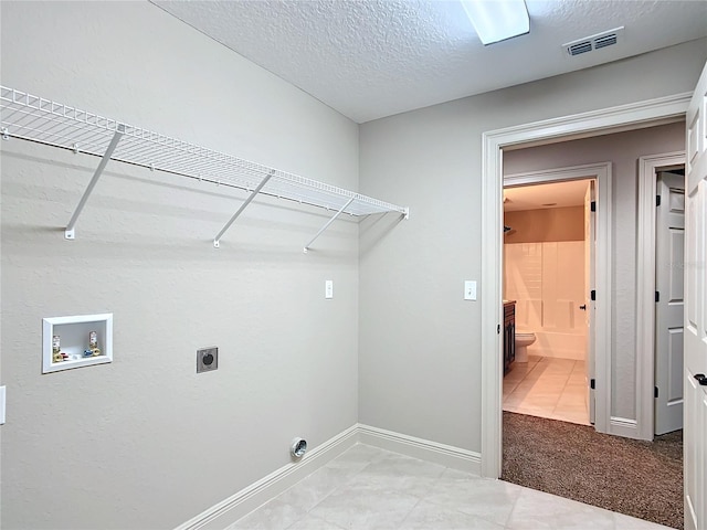 washroom with carpet flooring, hookup for a washing machine, a textured ceiling, and hookup for an electric dryer