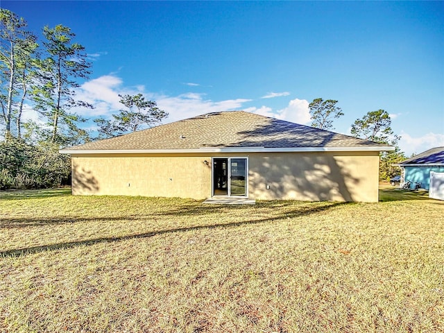 rear view of house with a lawn