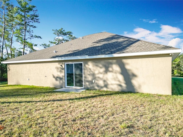 rear view of house with a yard