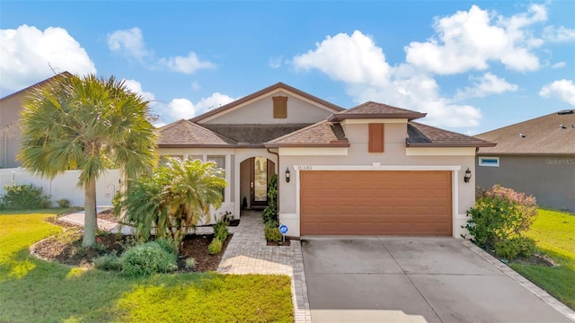 mediterranean / spanish-style home with a front yard and a garage