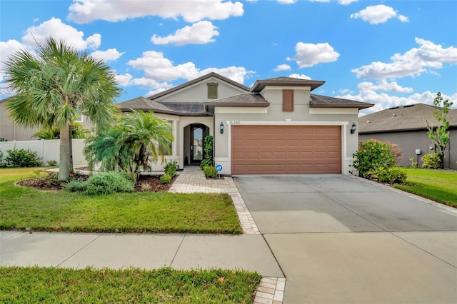 view of front of home with a garage and a front yard