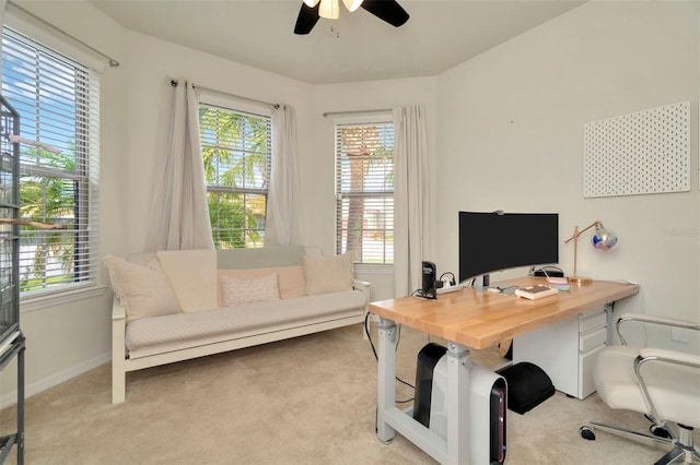 office area featuring light carpet, plenty of natural light, and ceiling fan