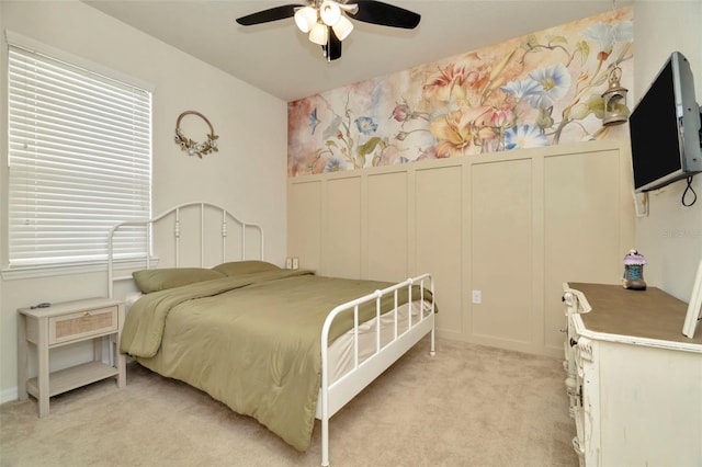 bedroom with light carpet and ceiling fan