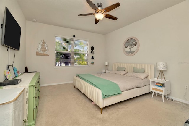 bedroom featuring light colored carpet and ceiling fan