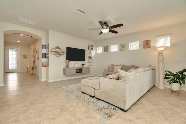 living room with ceiling fan and a wealth of natural light