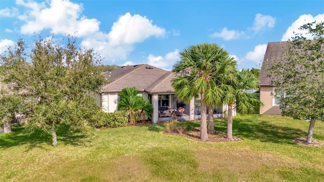 rear view of property with a lawn