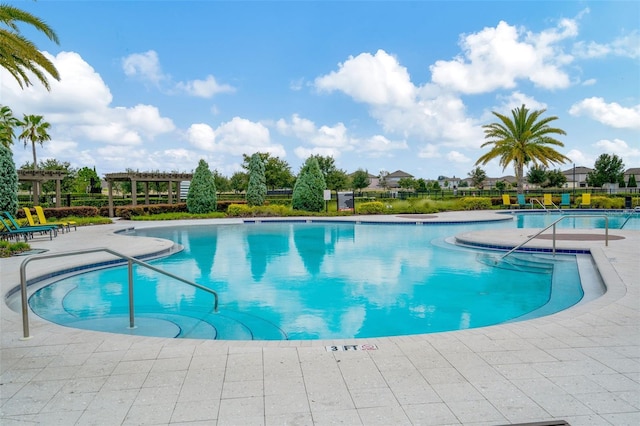 view of swimming pool with a patio area and a pergola