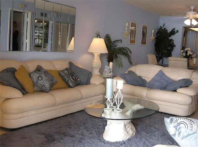 living room featuring carpet floors and ceiling fan