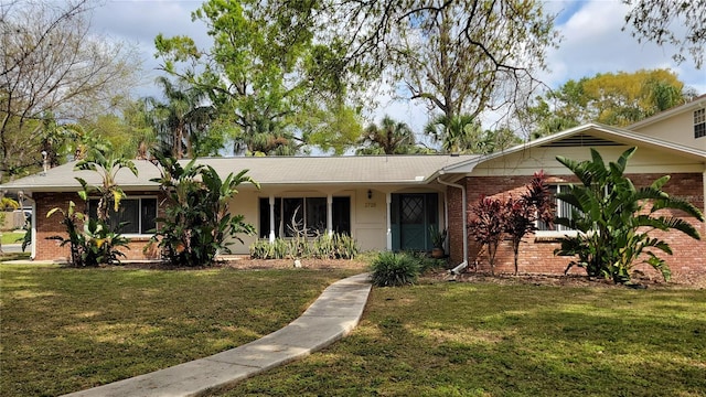 ranch-style house with brick siding and a front yard