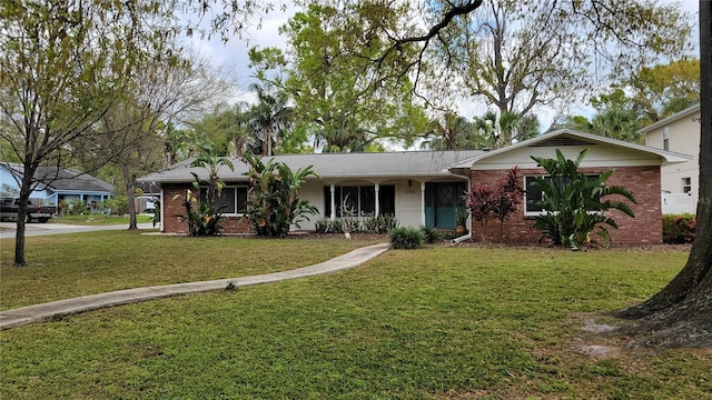 ranch-style house with brick siding and a front yard