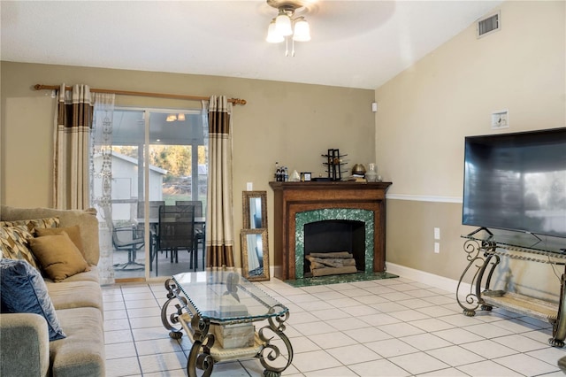 tiled living room with ceiling fan, a premium fireplace, and lofted ceiling