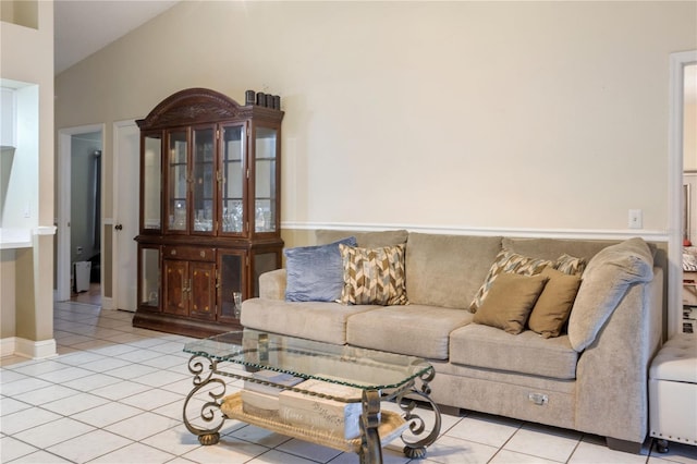 living room with light tile patterned floors and lofted ceiling