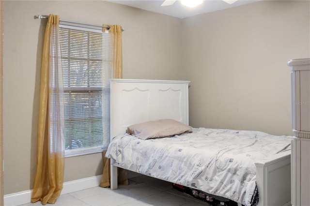 tiled bedroom featuring ceiling fan