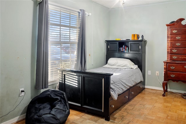 bedroom with light parquet flooring