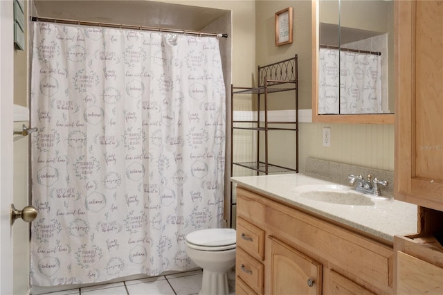 bathroom featuring tile patterned flooring, vanity, toilet, and curtained shower