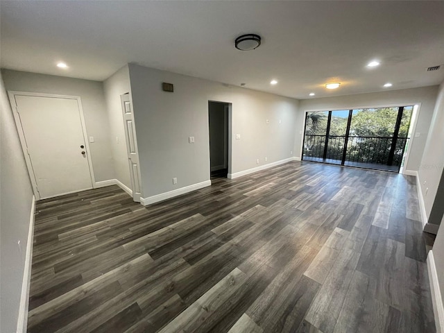 spare room with dark hardwood / wood-style flooring