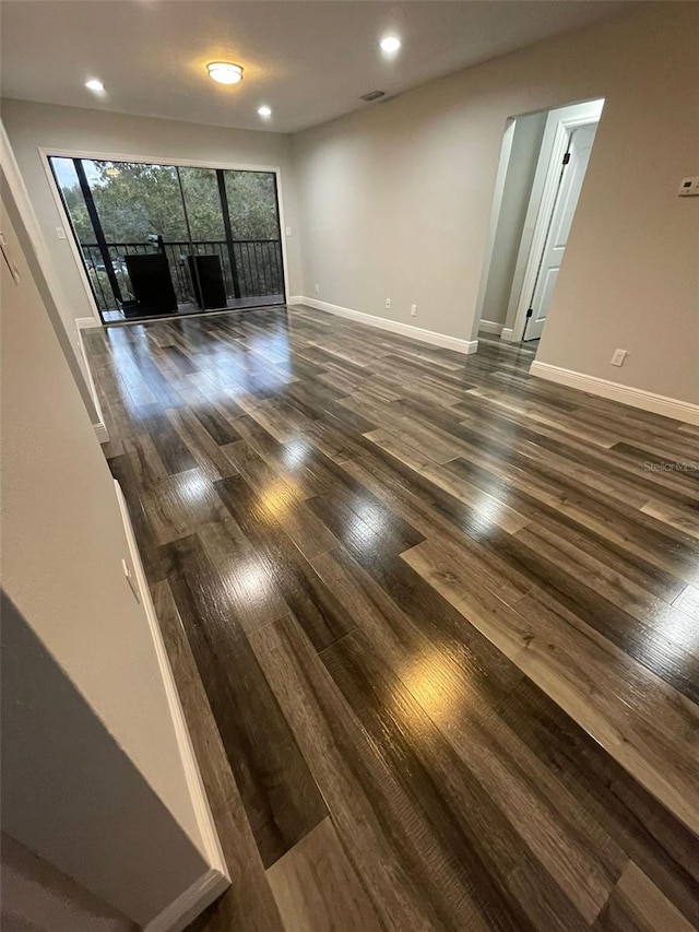 unfurnished room with dark hardwood / wood-style floors